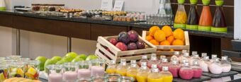 Selection of fresh fruit, yogurt, and juices arranged on a buffet table at NH Hotel M&uuml;nchen Neue Messe
