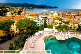 Rooftop pool area with deck chairs and umbrellas overlooking a coastal town and marina, B&B Hotel Park Hotel Suisse Santa Margherita Ligure