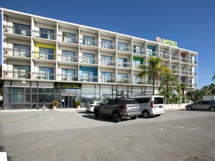 Modern four-story B&B Hotel Savona with balconies, colorful wall panels, parked cars, and clear blue sky above