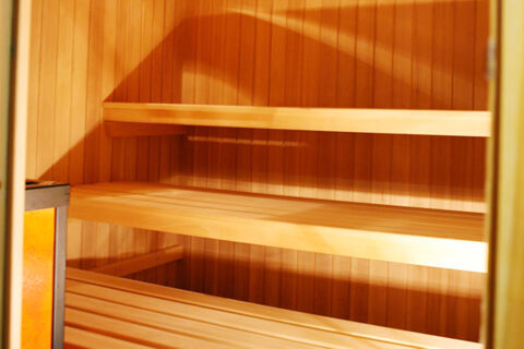 Interior view of wooden sauna benches and walls in a warm light setting at Hotel Gasthof Borest & Residence Riposo