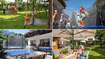 Children playing on a lawn with swings and playground equipment at Hotel Maria outdoor area under sunny skies
