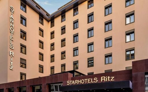 Exterior view of Starhotels Ritz with multiple windows and the hotel name visible on the building facade and entrance sign