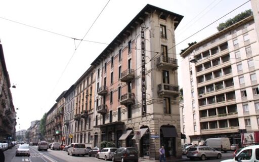 Tall narrow building with a vertical sign reading Demidoff Hotel on a busy city street near Casual Eclettico Milano Hotel