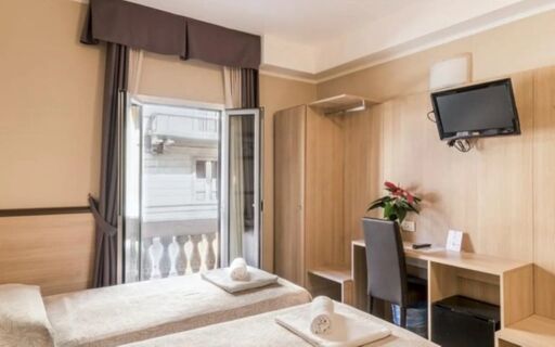 Hotel Brianza room with two single beds, open window with balcony, desk, chair, and wall-mounted TV
