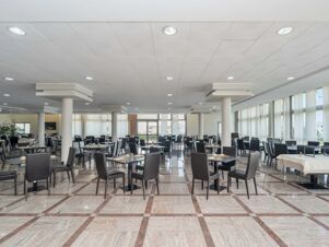 Dining area with black chairs and tables set with glassware and cutlery inside B&B HotelPark Hotel Mondov&igrave;