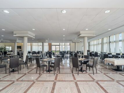 Dining area with black chairs and tables set with glassware and cutlery inside B&B HotelPark Hotel Mondov&igrave;