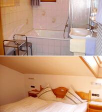 Bathroom with white tiled bathtub, sink, and shower area, and bedroom featuring wooden bed and slanted ceiling at G&auml;stehaus zur F&auml;rbe Ferien-Appartements