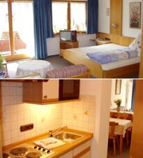 Guest room and kitchenette at G&auml;stehaus zur F&auml;rbe Ferien-Appartements featuring a bed, TV, blue curtains, stove, sink, and dining area