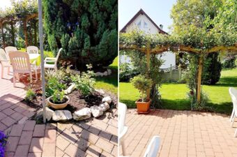 Outdoor patio area at G&auml;stehaus Rita with white plastic chairs, a table with a green cover, potted plants, and a garden archway with greenery