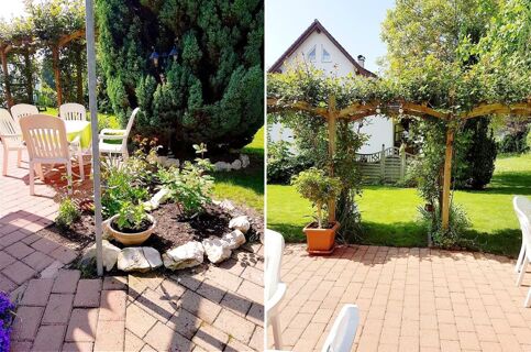 Outdoor patio area at G&auml;stehaus Rita with white plastic chairs, a table with a green cover, potted plants, and a garden archway with greenery