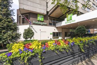 Exterior view of Holiday Inn London-Regent's Park with colorful flowers and greenery in front of the building entrance