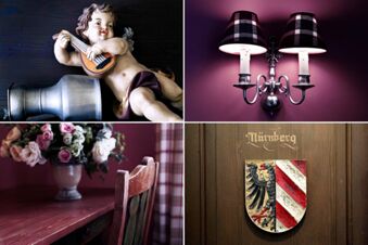 Alt N&uuml;rnberg Hotel 的裝飾特寫，木牆上有天使、壁燈、花束和紐倫堡盾徽。