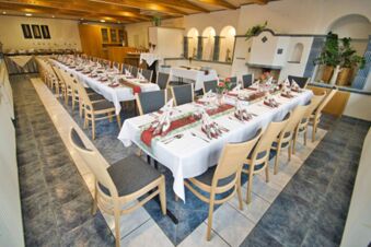 Dining room at Rh&ouml;ngasthof Zur Linde & Ferien-Appartements Rh&ouml;nsicht with long tables set with folded napkins and chairs