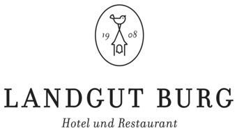 Das Logo des Hotel Landgut Burg zeigt ein minimalistisches Design mit einem Vogel, einer Glocke und dem Gr&uuml;ndungsjahr 1908 elegant dargestellt.
