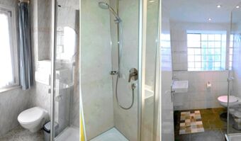 Helles Badezimmer mit Toilette, Dusche und Waschbecken in der Pension Arnold, ausgestattet mit hellen Fliesen und gro&szlig;em Fenster.