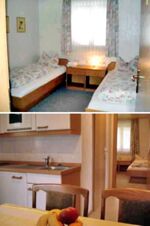 Small room with two single beds and floral bedding at Pension Graml Fr&uuml;hst&uuml;ckspension with a kitchen and dining table with fruit visible