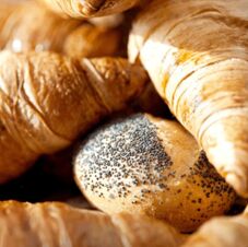 Close-up of croissants and a poppy seed bun arranged together as breakfast pastries at Hotel Hahnen
