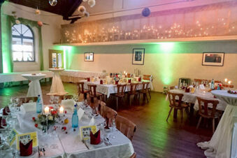 Dining room with white tablecloths, wooden chairs, candles, and green lighting at Winzerhotel Weingut Kinges-Kessel