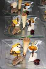 Dessert plates featuring a chocolate-filled cone, cr&egrave;me br&ucirc;l&eacute;e, fruit slices, and garnishes served at Winzerhotel Weingut Kinges-Kessel