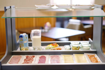 Buffet display with sliced deli meats, cheeses, yogurt jars, milk, and a carton at Lodner&acute;s Genie&szlig;erhotel & Hotel Drei Mohren
