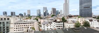 View of Frankfurt city skyline with modern skyscrapers and mid-rise buildings visible from NH Hotel Frankfurt Messe rooms