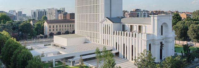 Modern white building with tall windows and greenery surrounding it at NH Collection Milano CityLife in a cityscape background