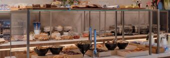 Buffet breakfast display with breads, croissants, dairy products, and pastries at Hotel NH Milano Corso Buenos Aires