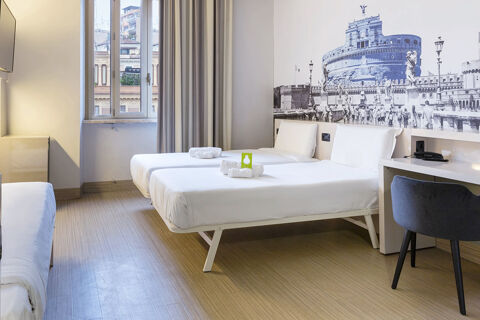 Two single beds with white bedding and towels in a hotel room with a mural of Castel Sant'Angelo at B&B Hotel Roma Trastevere