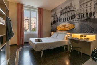 Double bed with white linens and folded towels near window with pink curtains in B&B Hotel Genova Principe room