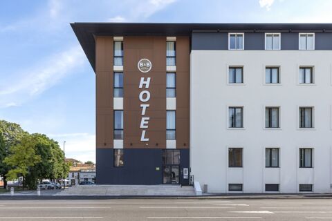 Exterior view of B&B Hotel Brescia showing the modern brown and white building facade with multiple windows and hotel signage