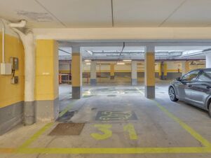 Empty parking space numbered 31 with electric vehicle charging markings inside B&B Hotel Cremona garage with a car parked nearby