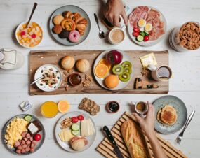 Breakfast spread with fruit, pastries, cheese, cold cuts, yogurt, coffee, and juice served at B&B Hotel Cremona
