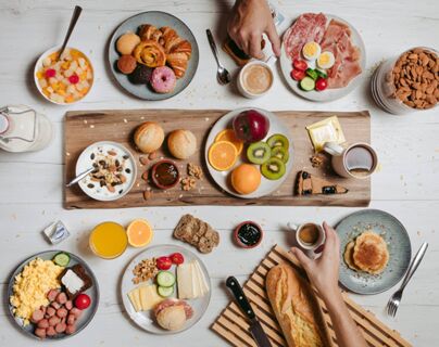 Breakfast spread with fruit, pastries, cheese, cold cuts, yogurt, coffee, and juice served at B&B Hotel Cremona