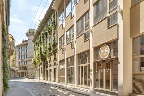 Street view of beige modern building with large windows and B&B Hotel Milano City Center Duomo sign on the facade