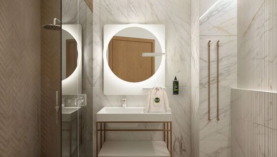 Modern bathroom interior at B&B Hotel Milano Duomo Velasca with illuminated round mirror, marble walls, and a glass shower area