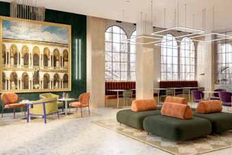 Lounge area at B&B Hotel Milano Duomo Velasca with green sofas, orange and purple chairs, and tall arched windows with city views