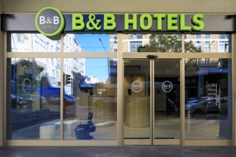Glass front entrance with automatic sliding doors and green B&B HOTEL S lettering above at B&B Hotel Catania City Center