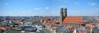 Panoramic cityscape of Munich with the Frauenkirche cathedral and surrounding rooftops near NH Hotel M&uuml;nchen Dornach on a clear day