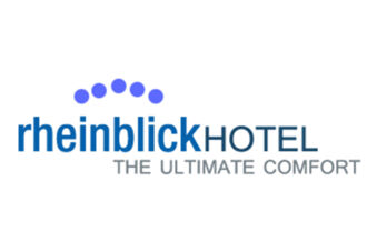 Das Logo vom Hotel Haus Rheinblick zeigt den Schriftzug "rheinblickHOTEL" mit dem Slogan "The Ultimate Comfort" und blauen Punkten dar&uuml;ber.
